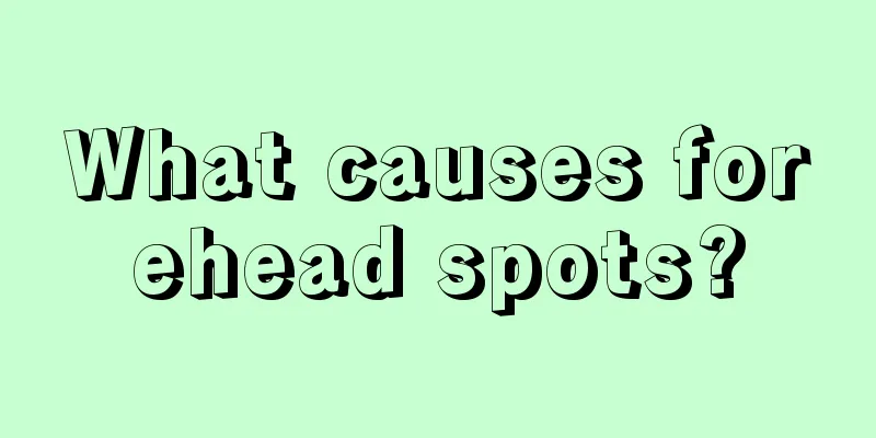 What causes forehead spots?